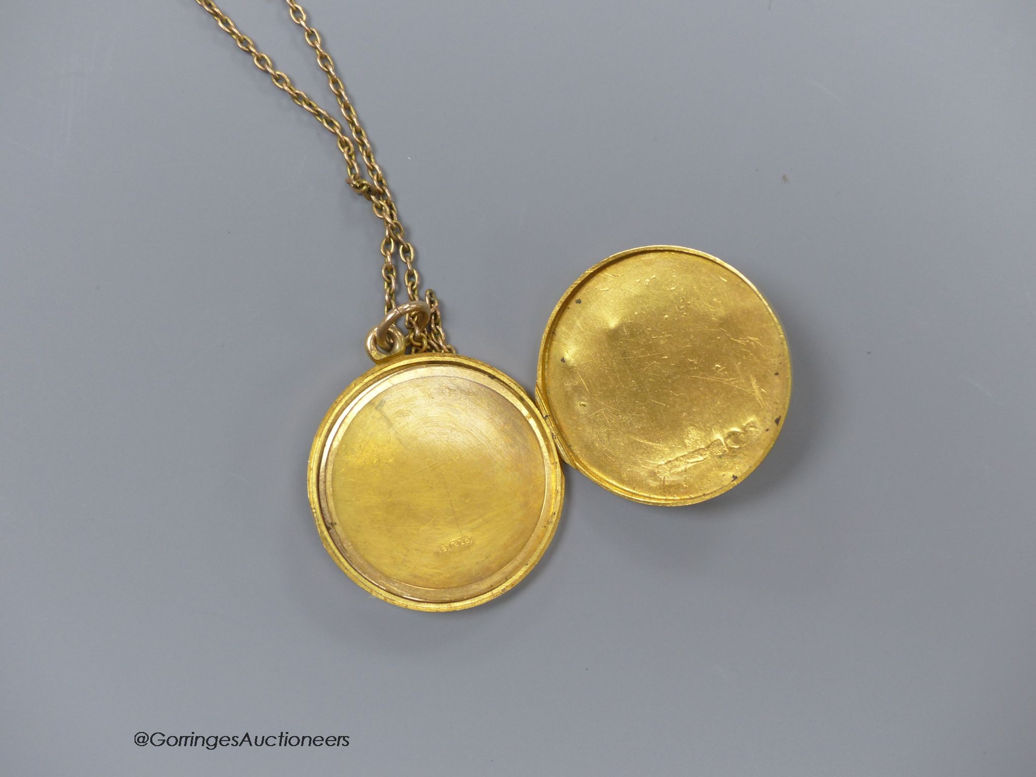 A 15ct engraved gold locket on a fine 9ct gold chain, 8.6g, 2.5cm.